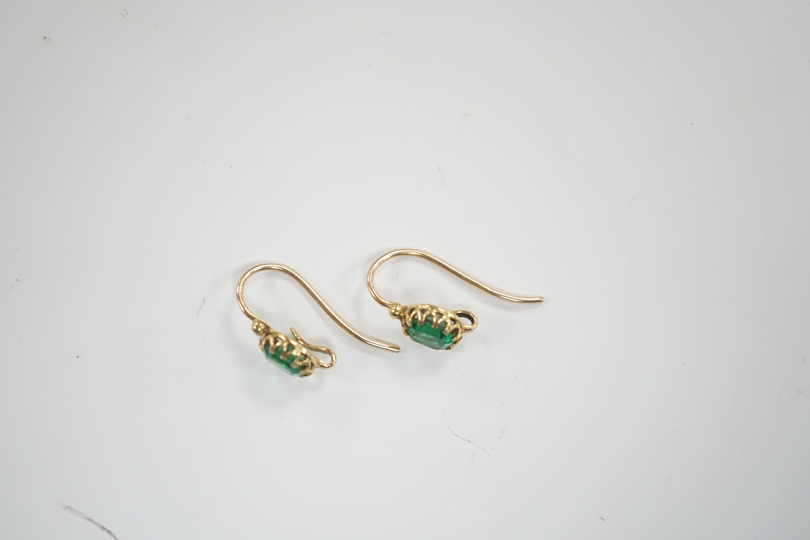 A pair of Victorian yellow metal and emerald set earrings (lacking drops), 6mm diameter, gross weight 2.5 grams